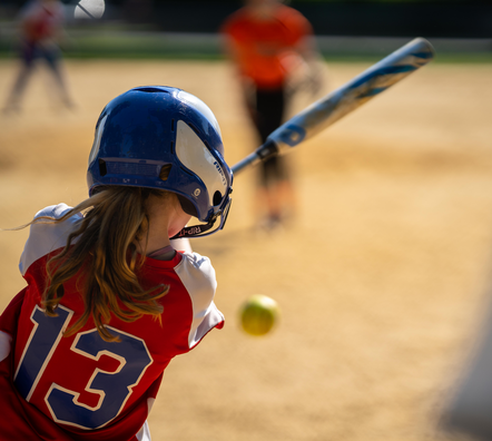 Child playing softball