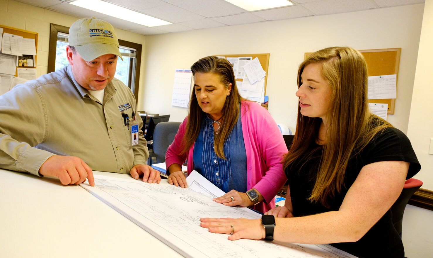 Employees looking at map