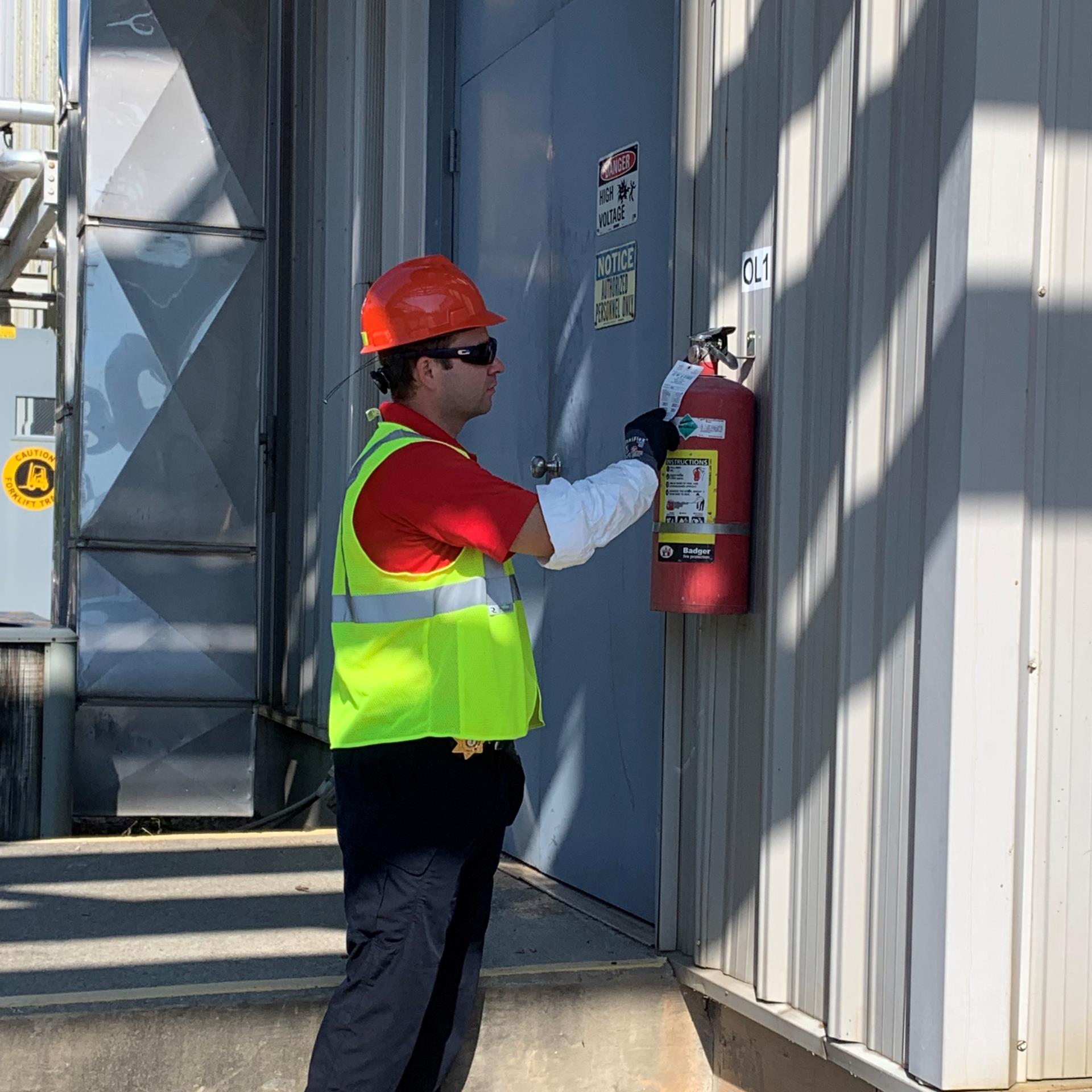 Fire Marshal examining fire extinguisher 