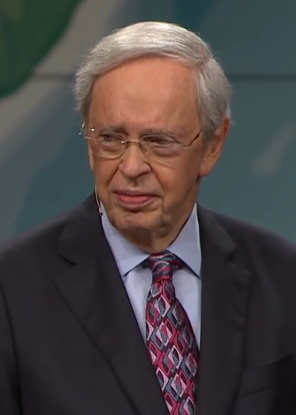 Photo of Charles Stanley, a pastor wearing glasses and a mic